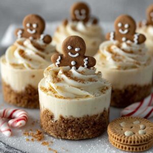 No-Bake Gingerbread Cheesecake Cups 12 No-bake gingerbread cheesecake cups with creamy spiced filling, gingersnap crust, and mini gingerbread cookies on top.