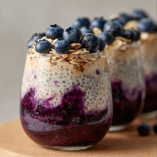 Easy Blueberry Overnight Oats 30 Blueberry overnight oats in glass jar with Greek yogurt, chia seeds, rolled oats and fresh blueberries layered on top