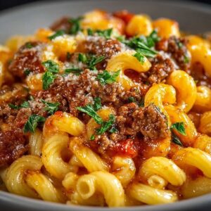 Easy One Pot Beefaroni Recipe 13 One pot beefaroni in a bowl, featuring elbow macaroni coated in cheesy tomato meat sauce with ground beef and fresh parsley